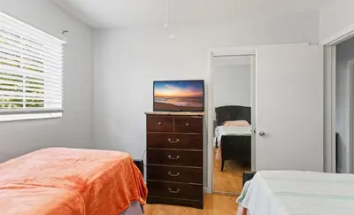 a bedroom with a bed and a dresser and a mirror at Spacious Home With King Bed Near Stadium in Norland
