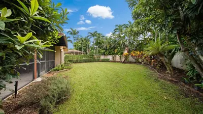 a yard of a house with green grass and trees at Private Entrance King Room and Private Bath UMiami in Miami