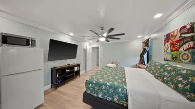 a bedroom with a bed and a flat screen tv at Private Entrance King Room and Private Bath UMiami in Miami