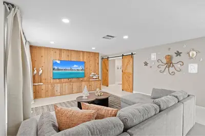 a living room with a couch and a tv at 6BR 3BA Heated Pool Miami Vacation in Miami