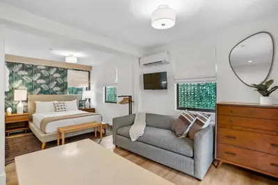 a living room with a couch and a bed at The Firefly in Miami Beach
