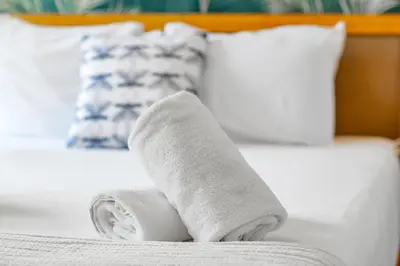 a pair of white socks sitting on a bed at The Firefly in Miami Beach