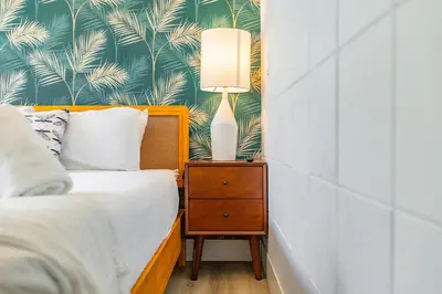 a bedroom with a bed and a lamp on a nightstand at The Firefly in Miami Beach