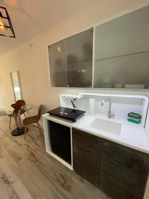 a kitchen with a sink and a mirror at Agave on the Beach in Miami Beach