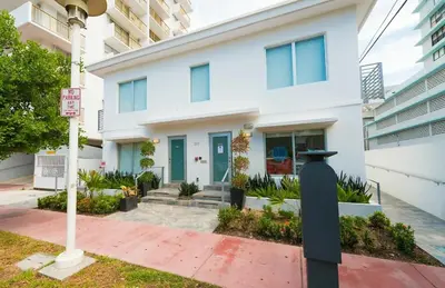 a white building with a parking meter in front of it at Agave on the Beach in Miami Beach
