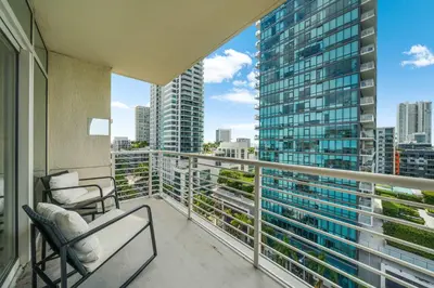a balcony with two chairs and a view of a city at Midtown Muse -Walkable Cozy amenity bldg w parking in Miami