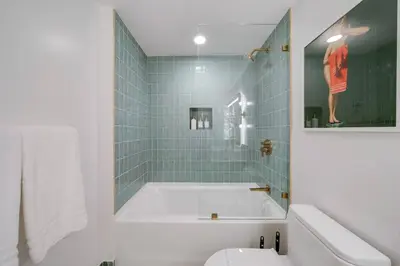 a bathroom with a bath tub and a toilet at Bellini Breeze - Cozy Central Miami Pool and Gym in Miami