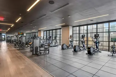 a gym with treadmills and elliptical machines at Bellini Breeze - Cozy Central Miami Pool and Gym in Miami