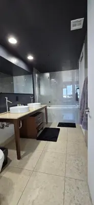 a large bathroom with two sinks and a shower at Miami brickell condo ocean view in Miami