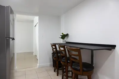 a dining room table with chairs and a black counter at Beachfront 1 BR Apartment with Kitchen- Sian in Hollywood