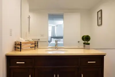 a bathroom counter with a sink and a mirror at Beachfront 1 BR Apartment with Kitchen- Sian in Hollywood