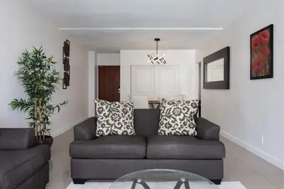 a living room with a couch and a table at Beachfront 1 BR Apartment with Kitchen- Sian in Hollywood