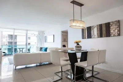 a dining room and living room with a table and chairs at Beachfront 2 BR Apartment full Kitchen- Sian in Hollywood