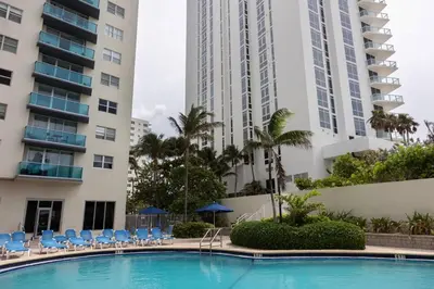 a swimming pool in front of two tall buildings at Beachfront 2 BR Apartment full Kitchen- Sian in Hollywood
