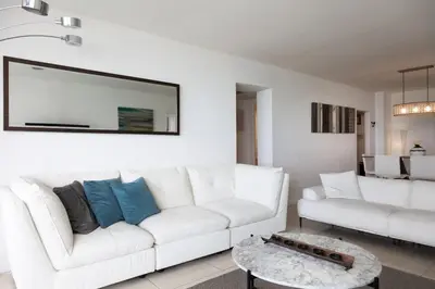 a living room with a white couch and a table at Beachfront 2 BR Apartment full Kitchen- Sian in Hollywood