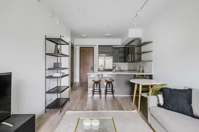 a living room and kitchen with a couch and a table at Blueground Brickell pool wd near city center MIA-127 in Miami