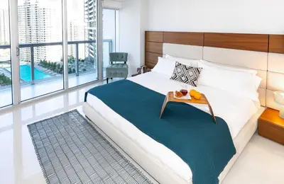 a bedroom with a large bed with a tray on it at MVR-Designer Stay in Heart of Brickell in Miami