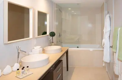 a white bathroom with two sinks and a bath tub at MVR-Designer Stay in Heart of Brickell in Miami