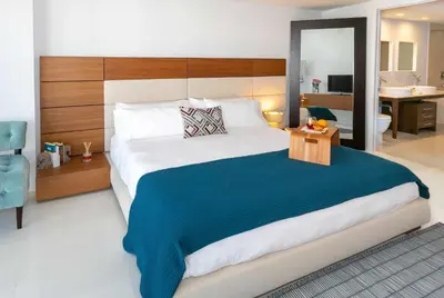 a bedroom with a large bed and a bathroom at MVR-Designer Stay in Heart of Brickell in Miami