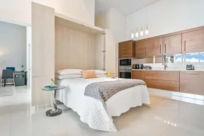a bedroom with a bed and a kitchen at MVR-Water Views & Modern Luxury in Miami
