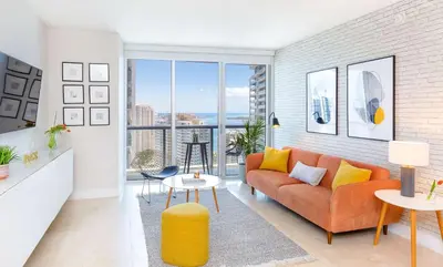 a living room with a orange couch and yellow pillows at MVR - Floor 45 Views & Spa Bliss in Miami