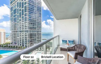 a balcony with a view of a building and the ocean at MVR - Brickell Icon w Massive Pool & Spa in Miami