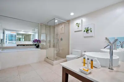 a bathroom with a tub and a sink and a shower at MVR - Designer Condo in Prime Brickell in Miami