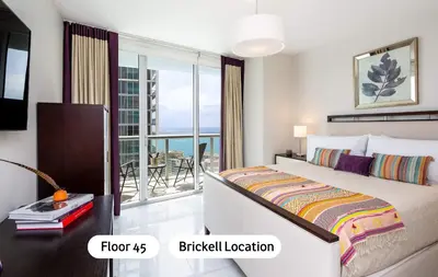 a bedroom with a bed and a balcony at MVR - The Ultimate Brickell Balcony in Miami