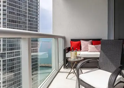 a balcony with a bed and a table and chairs at MVR - The Ultimate Brickell Balcony in Miami