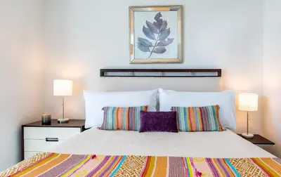 a bedroom with a large bed with two lamps at MVR - The Ultimate Brickell Balcony in Miami