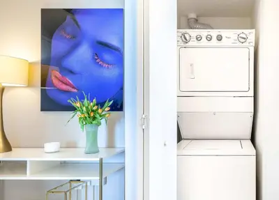 a kitchen with a vase of flowers next to a refrigerator at MVR - Wake to Water & Skyline Views in Miami