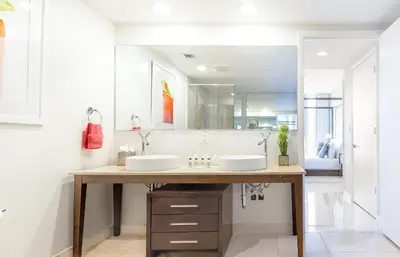 a bathroom with two sinks and a large mirror at MVR - Wake to Water & Skyline Views in Miami