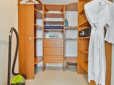 a closet with a wooden cabinet and a dresser at MVR - High-Rise Escape with Spa Access in Miami