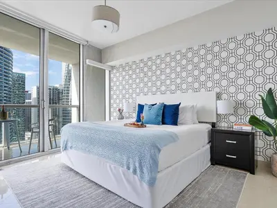a bedroom with a large white bed and a large window at MVR - High-Rise Escape with Spa Access in Miami