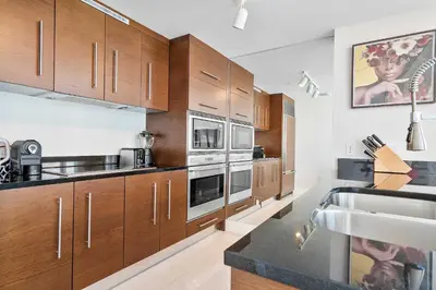 a kitchen with wooden cabinets and stainless steel appliances at MVR - Icon Brickell Beauty with Views in Miami