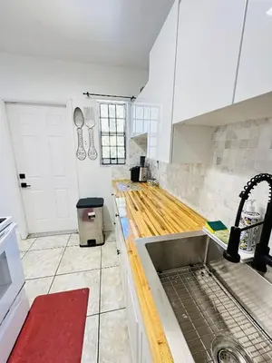 a kitchen with a sink and a counter top at Miami Casa in Miami Gardens