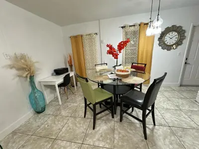 a dining room with a table and chairs at Miami Casa in Miami Gardens