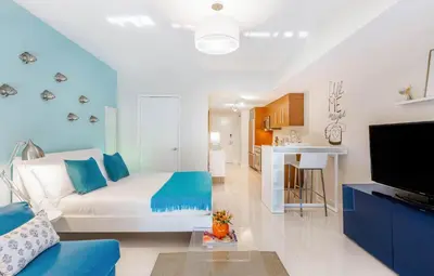 a living room with a white couch and blue accents at MVR - Stylish Escape in Icon Brickell in Miami