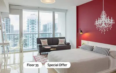 a bedroom with a bed and a couch and a chandelier at MVR - River & City Views Brickell Center LuxSPA in Miami