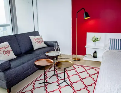 a living room with a blue couch and a red wall at MVR - River & City Views Brickell Center LuxSPA in Miami