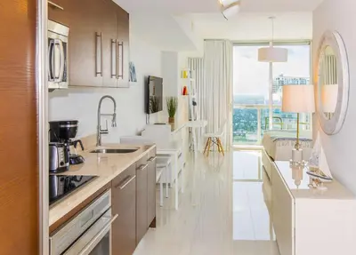 a kitchen with white counters and a large window at MVR - Luxury Stay with Spa & Views in Miami