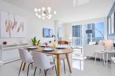 a dining room and living room with a table and chairs at MVR - High-End Condo with Miami Views in Miami