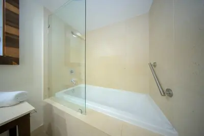 a bathroom with a tub and a glass shower at MVR Balcony Bliss in Miami in Miami