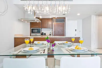 a dining room and kitchen with a glass table and chairs at MVR - Best Views in Brickell in Miami