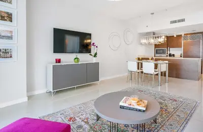 a living room with a table and a kitchen at MVR - Best Views in Brickell in Miami