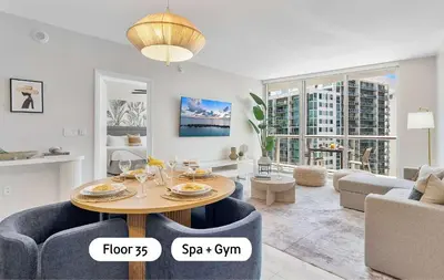 a living room with a table and a couch at MVR - Wake Up to Brickell-s Best Views in Miami