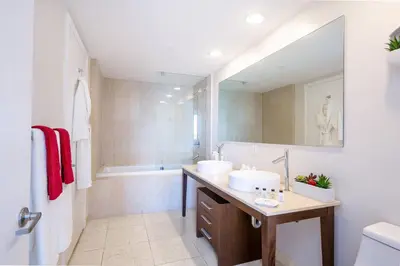 a bathroom with two sinks and a tub at MVR Bright & Airy Condo with Views in Miami