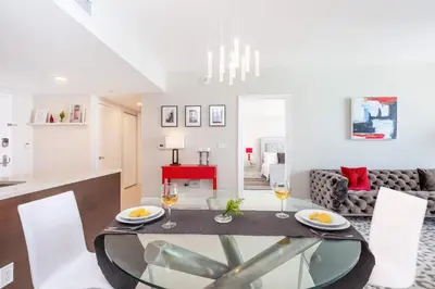 a dining room and kitchen with a glass table and chairs at MVR Bright & Airy Condo with Views in Miami