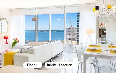a white living room with a view of the ocean at MVR - High-Floor Luxury with Iconic Views in Miami