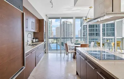 a kitchen with a table and a view of the city at MVR - Luxury Tower Stay with Miami Views in Miami